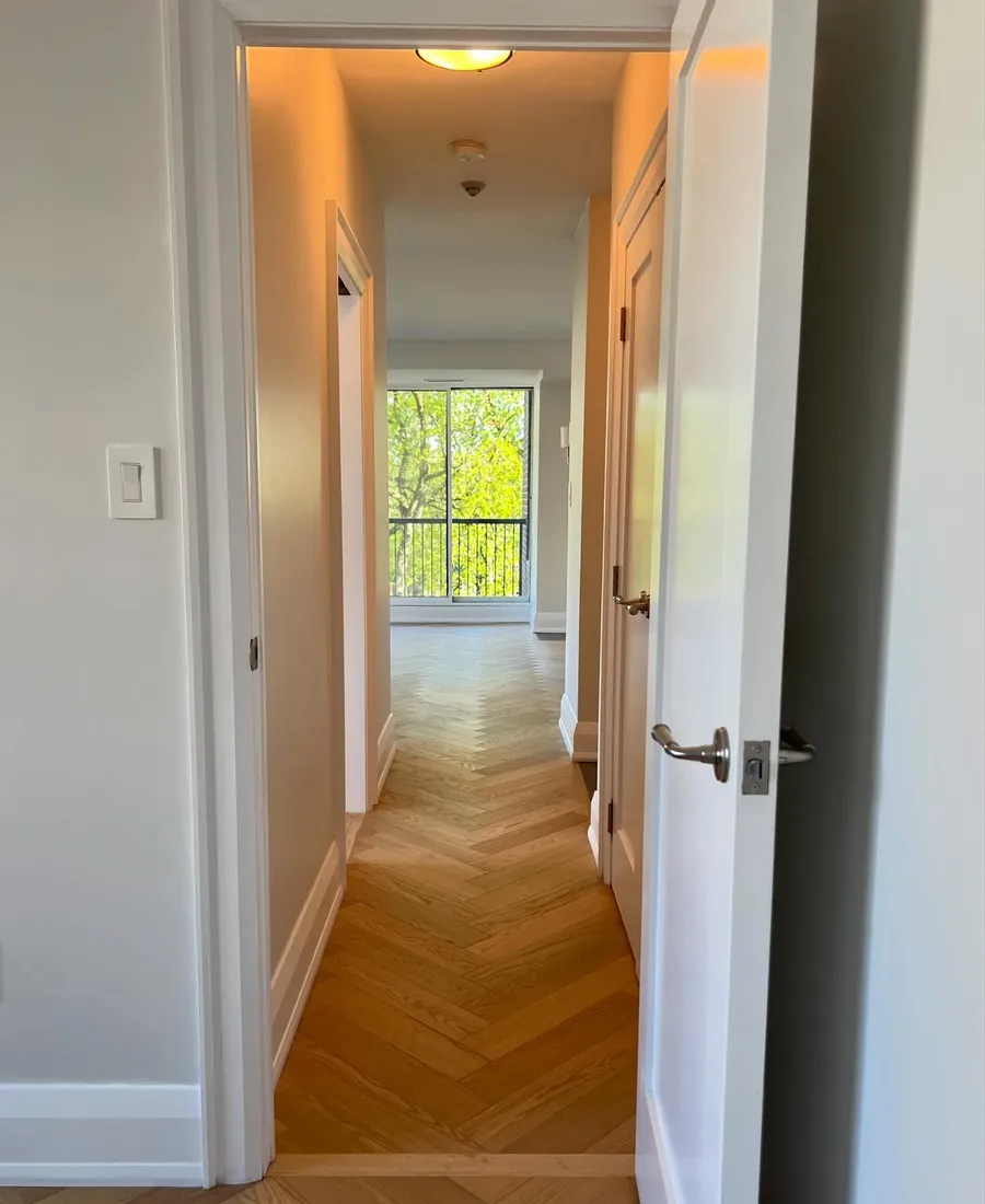 Freshly finished hallway with smooth painted walls and herringbone floor