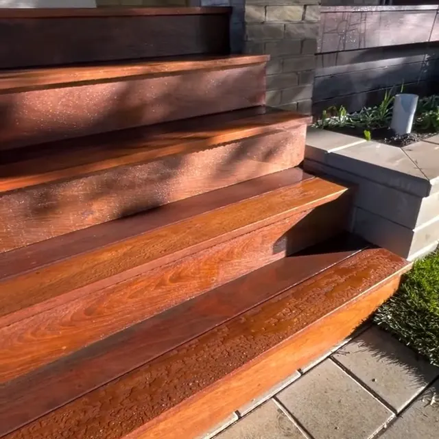 Finished hardwood steps and stone patio detail